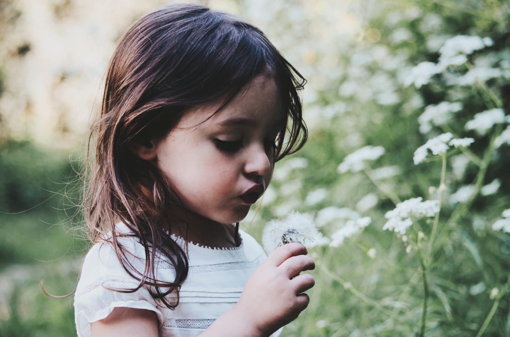child outside with flower