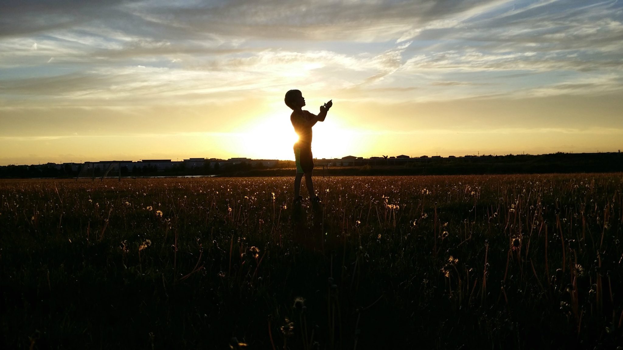 child outside sunset