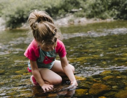 girl playing in water outside