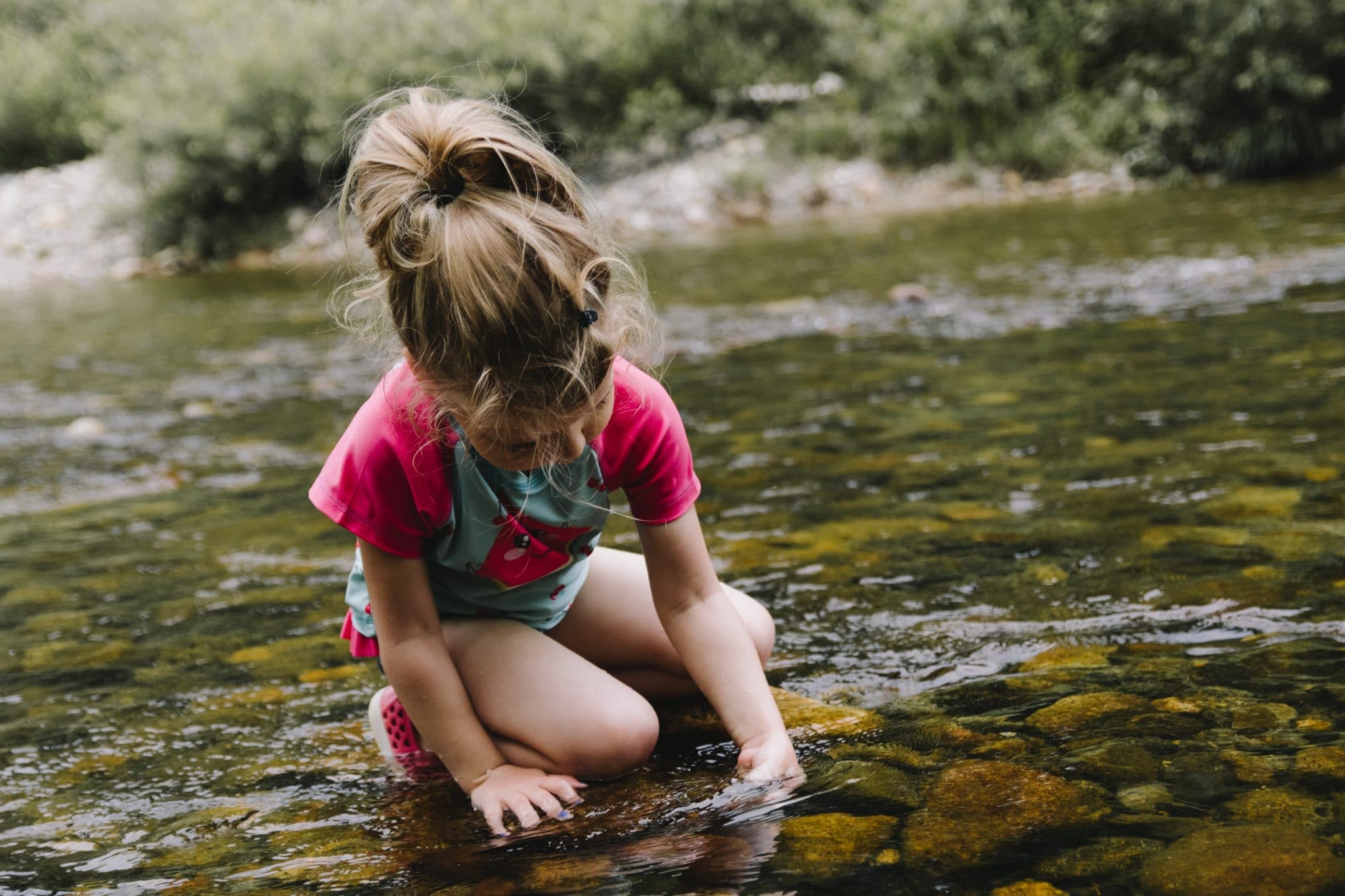 girl playing in water outside