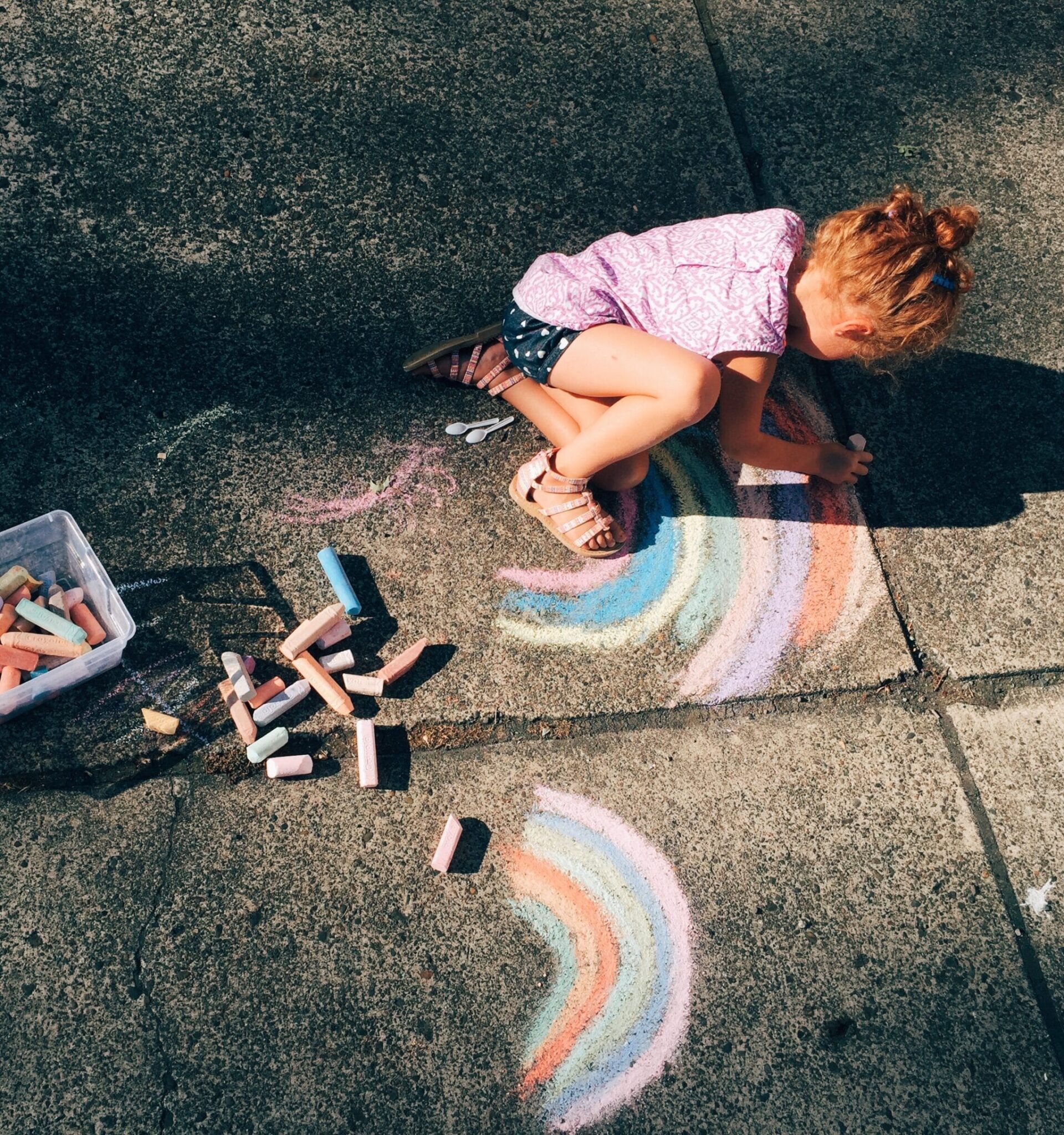 child drawing outside