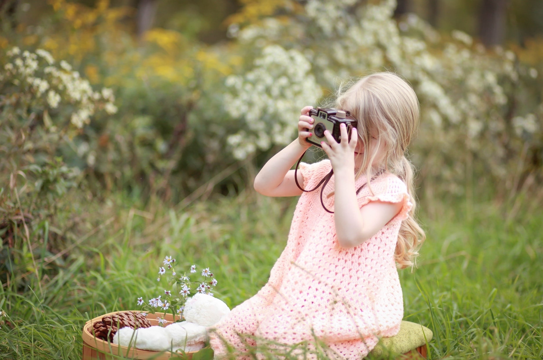child taking photo outside