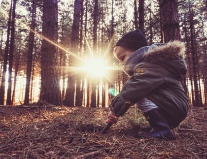 child in sunbeam outside