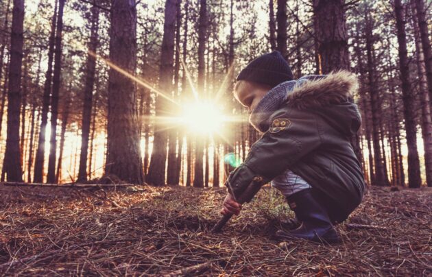 child in sunbeam outside