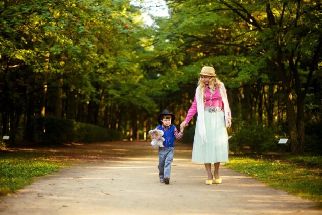 mother and child walk by trees