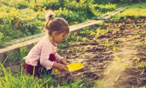child playing in dirt