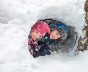 Children playing in a snow cave