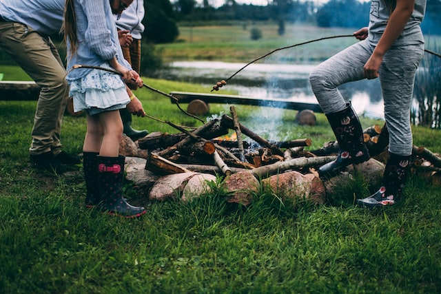 children toasting marshmallows at campfire