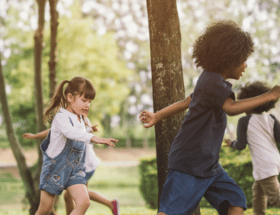 children playing outside by a tree