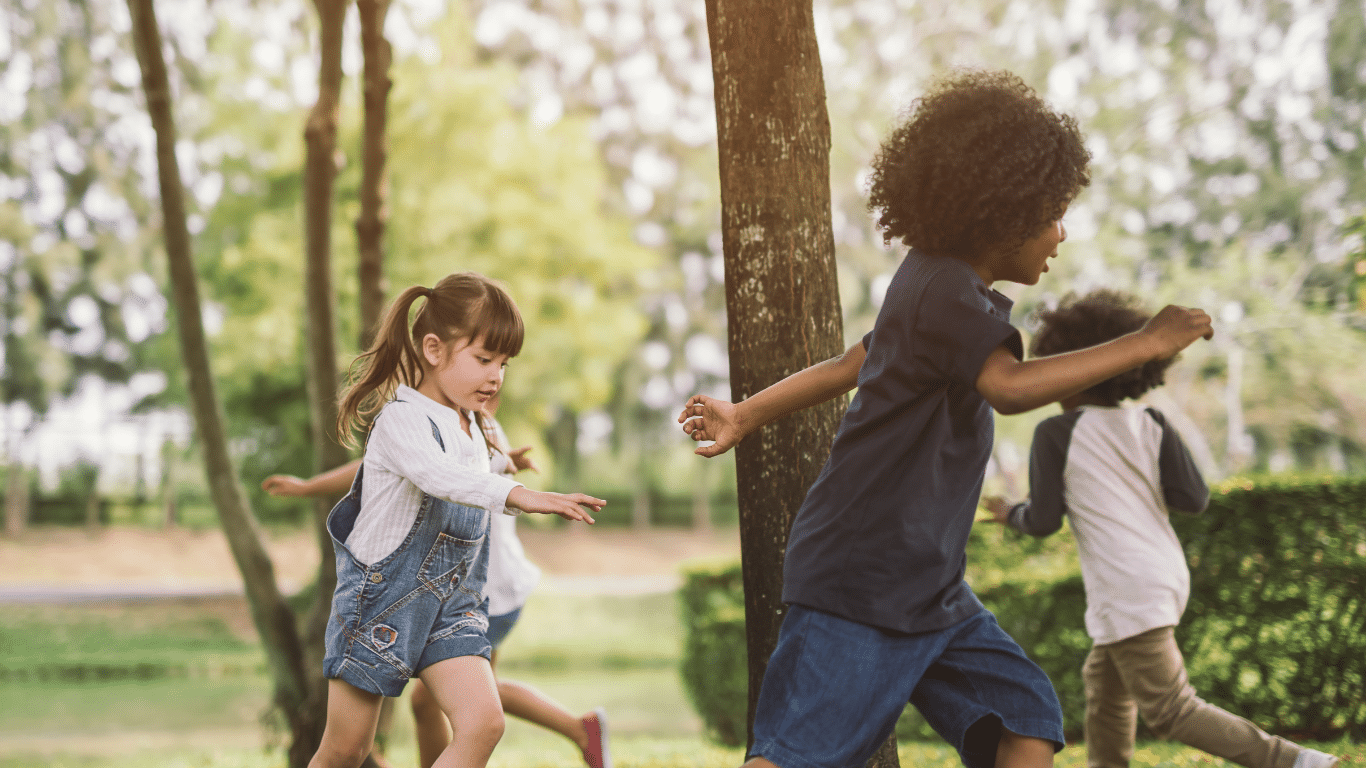 children playing outside by a tree